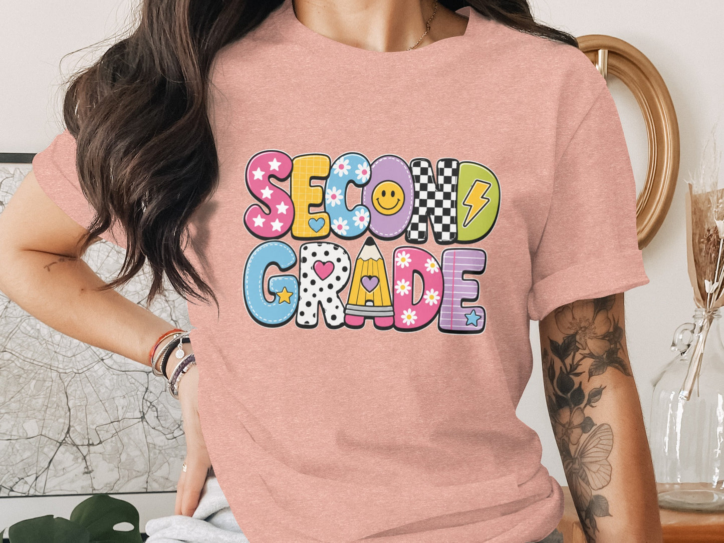 Pink t-shirt with "Second Grade" graphic in playful, patterned letters.