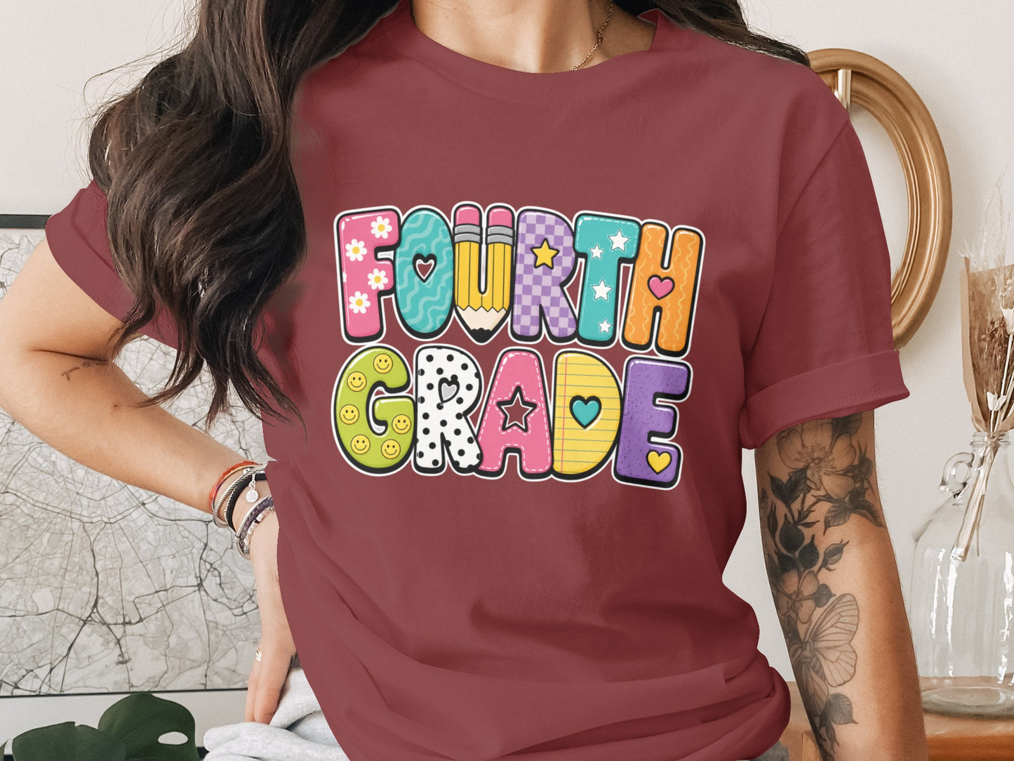 Burgundy t-shirt with "Fourth Grade" text in colorful, patterned letters.