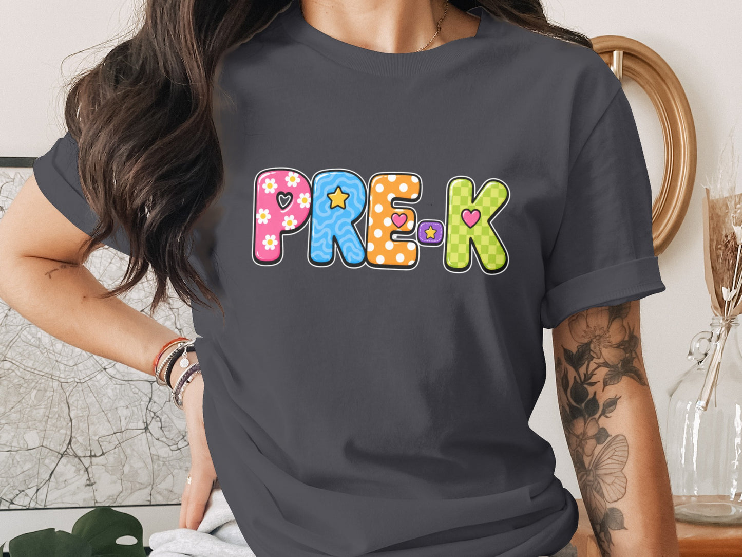 PRE-K graphic with colorful, patterned letters on a dark grey t-shirt.