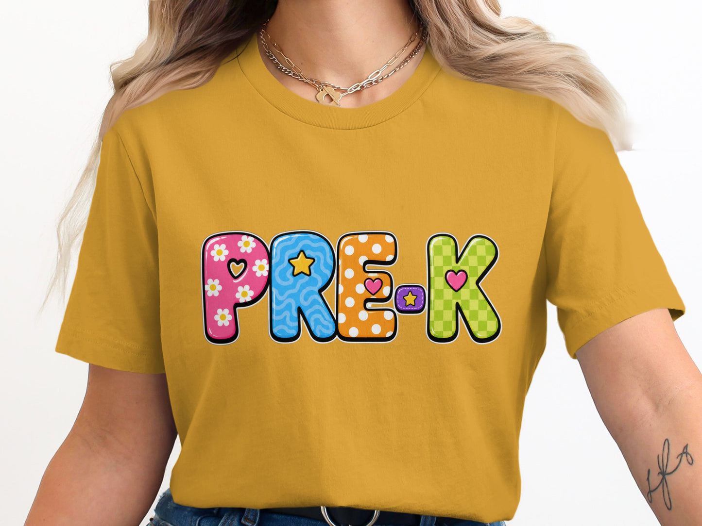 Pre-K text with colorful, decorative letters on a mustard yellow t-shirt.