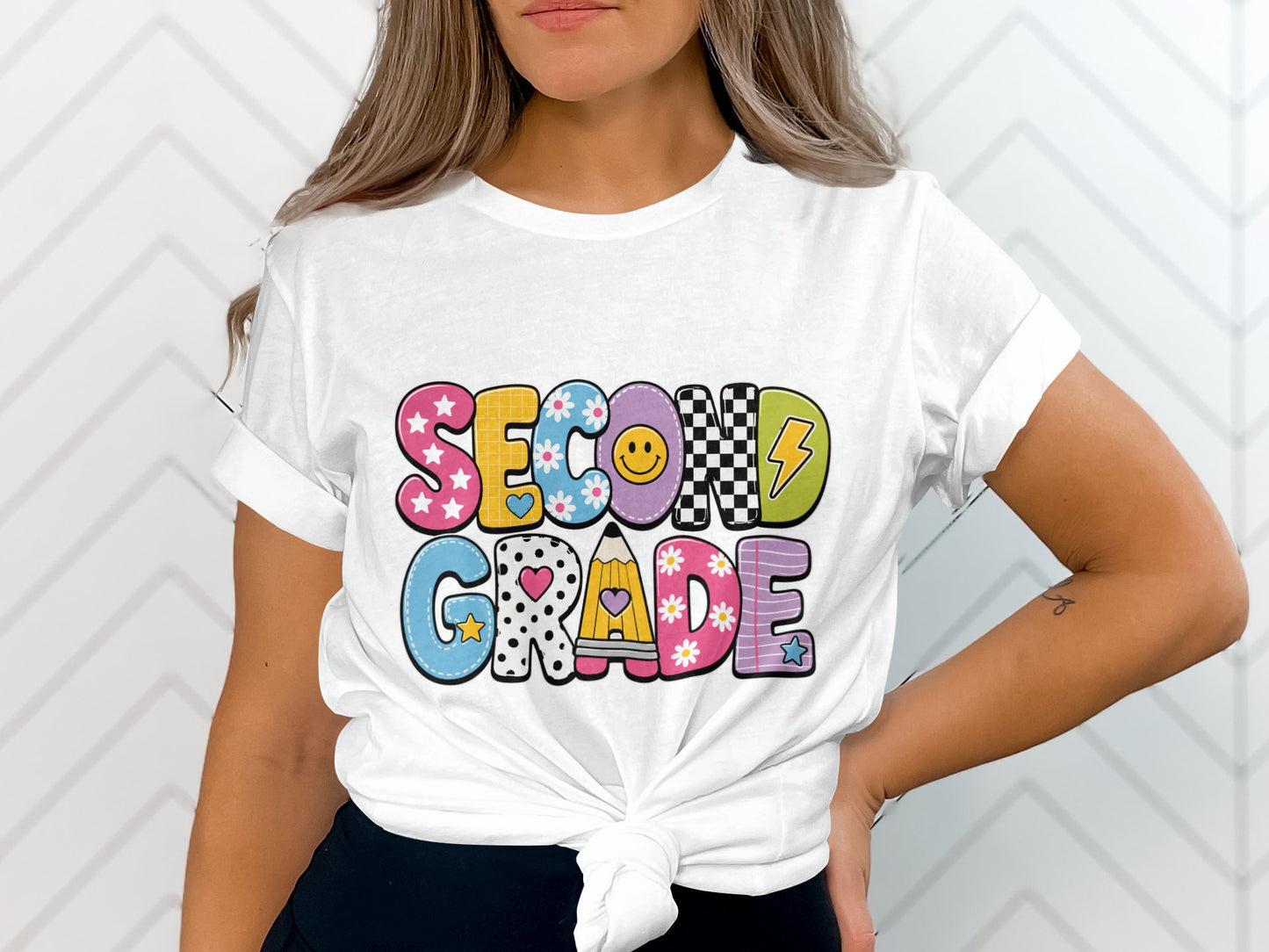 White t-shirt with colorful "SECOND GRADE" text in playful lettering.
