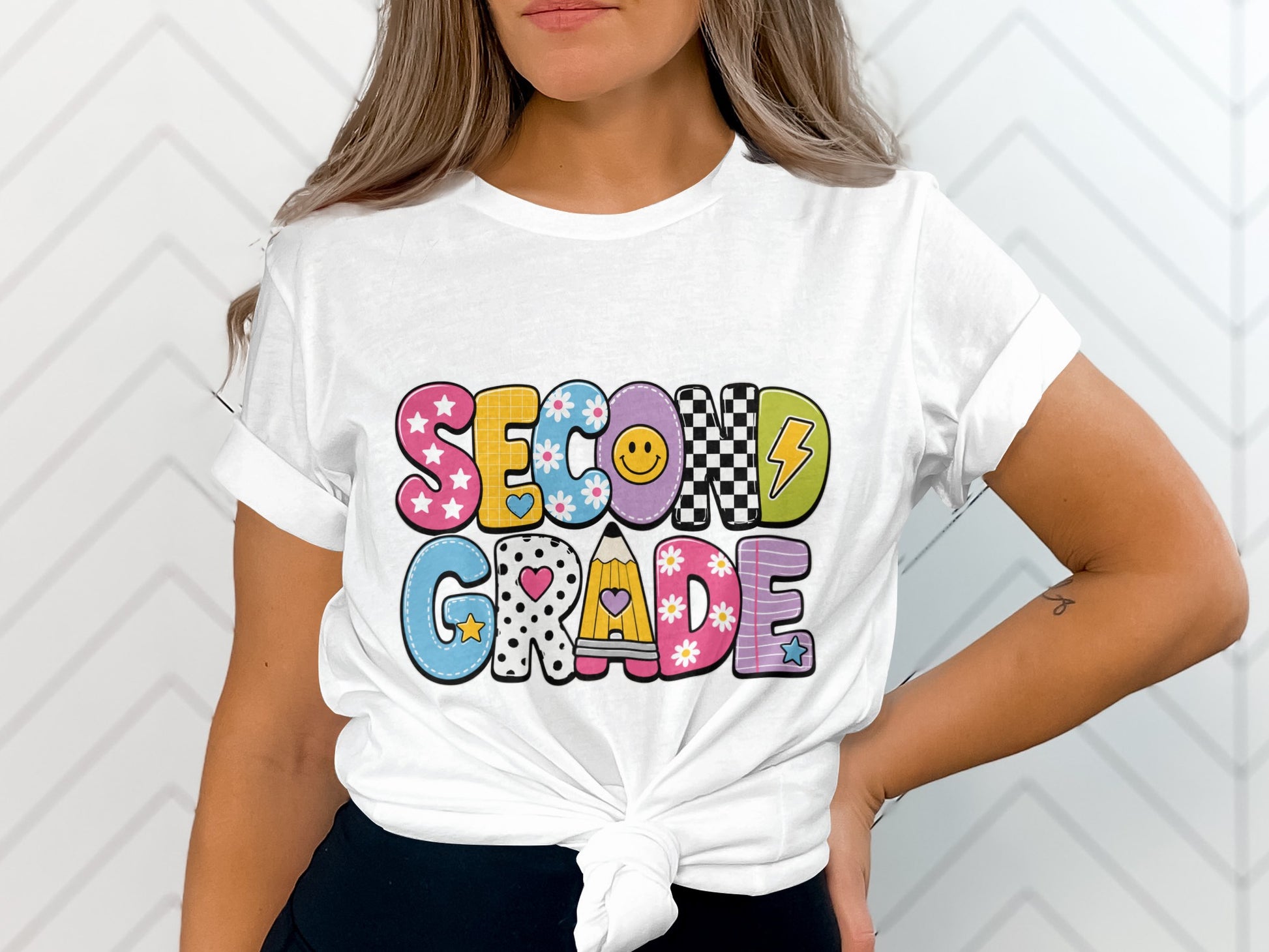 White t-shirt with colorful "SECOND GRADE" text in playful lettering.