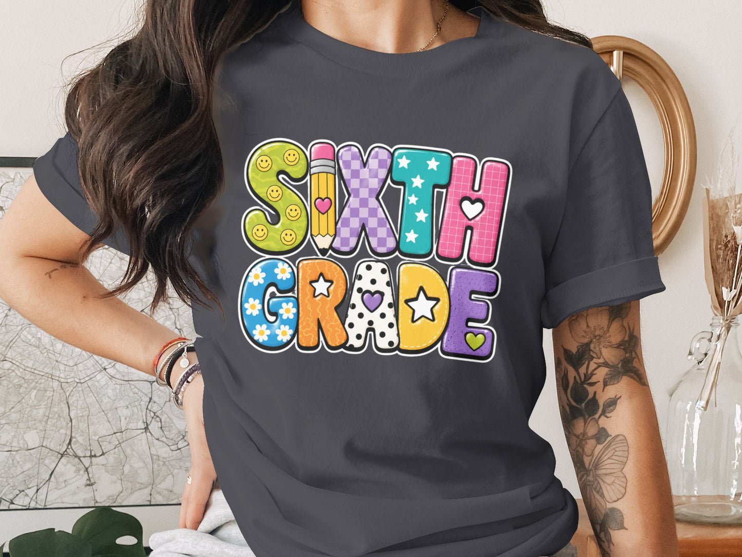Sixth Grade text with fun, colorful letters on a dark t-shirt.