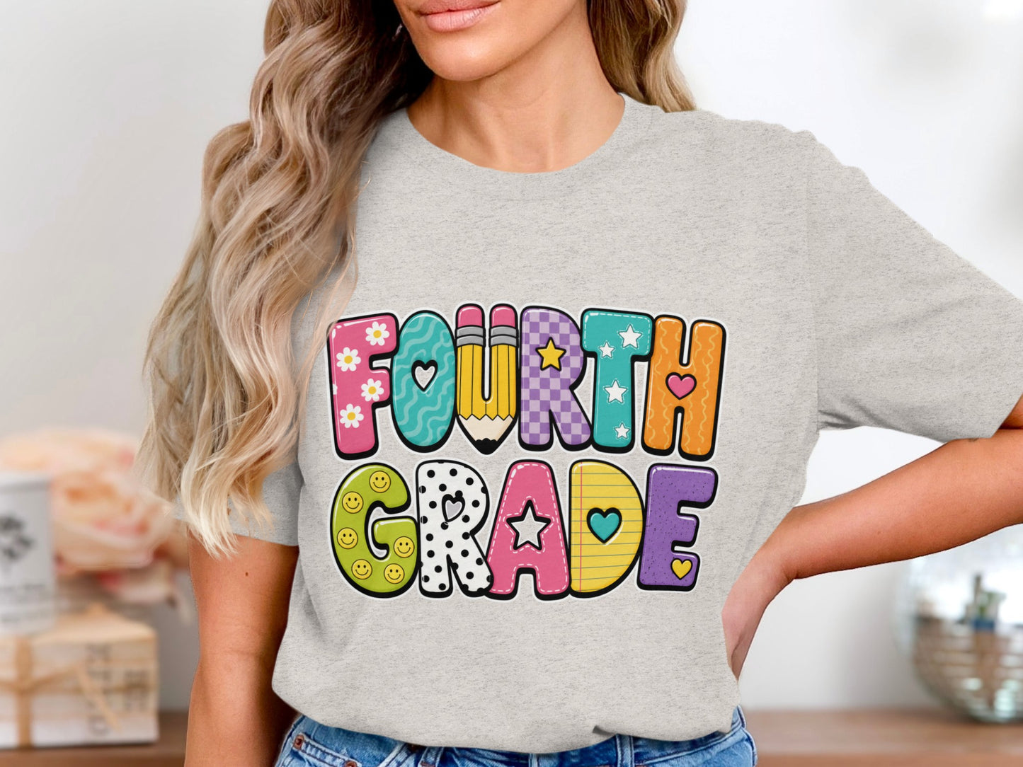 Light gray t-shirt with "Fourth Grade" text in colorful, patterned letters.