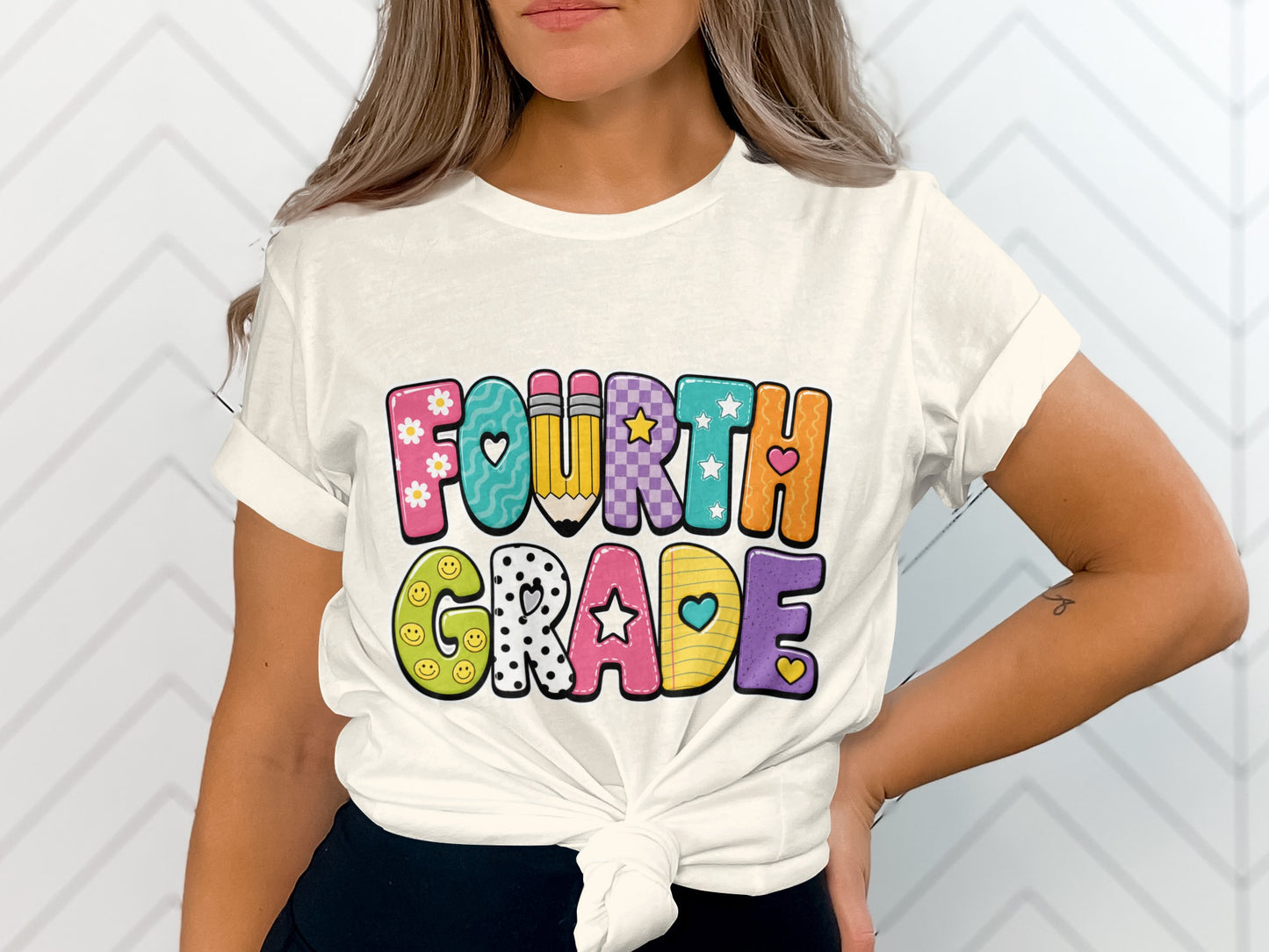 White t-shirt with colorful "FOURTH GRADE" text and school-themed graphics.