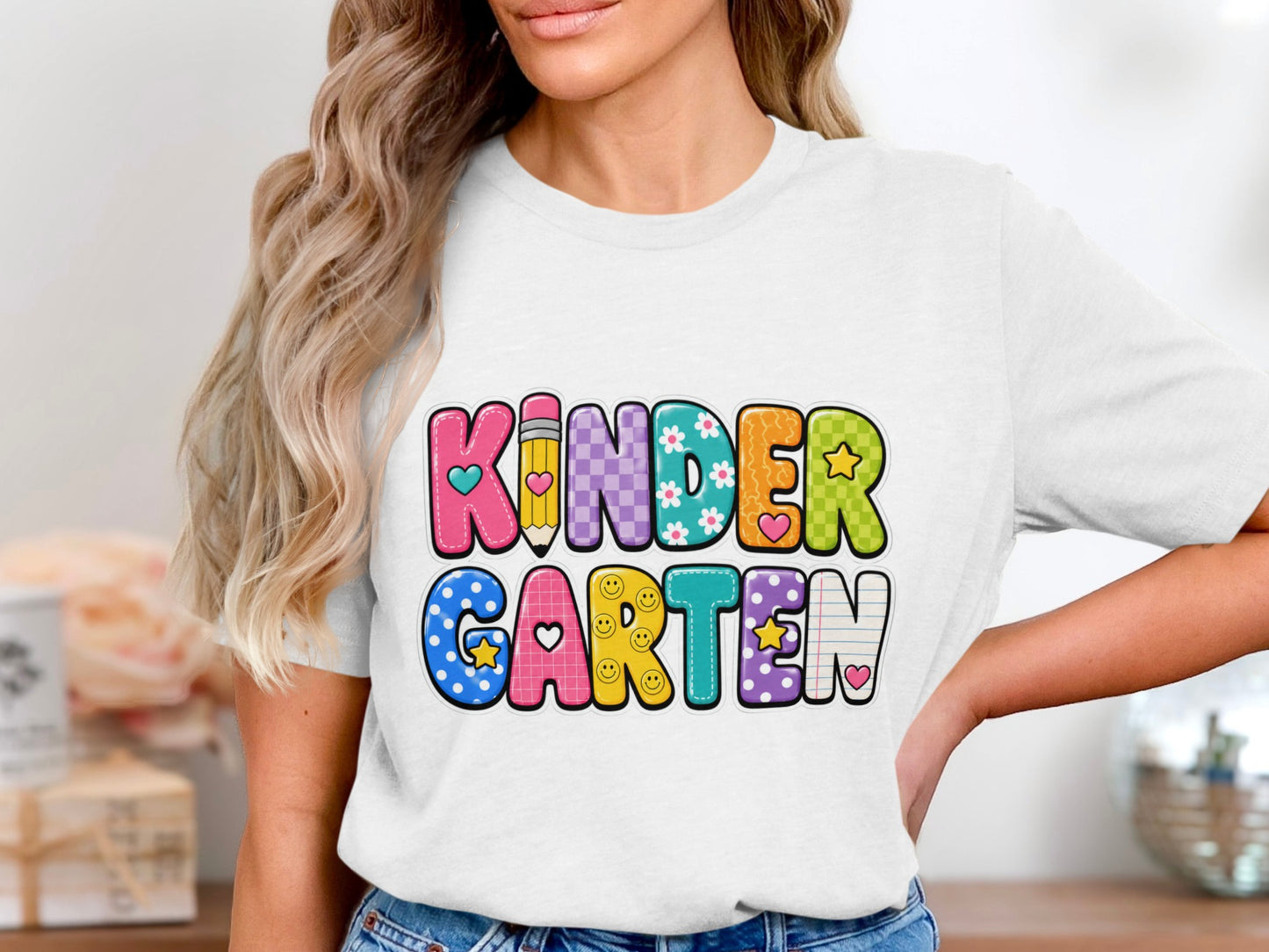 White t-shirt with colorful "Kindergarten" text and school-themed designs.