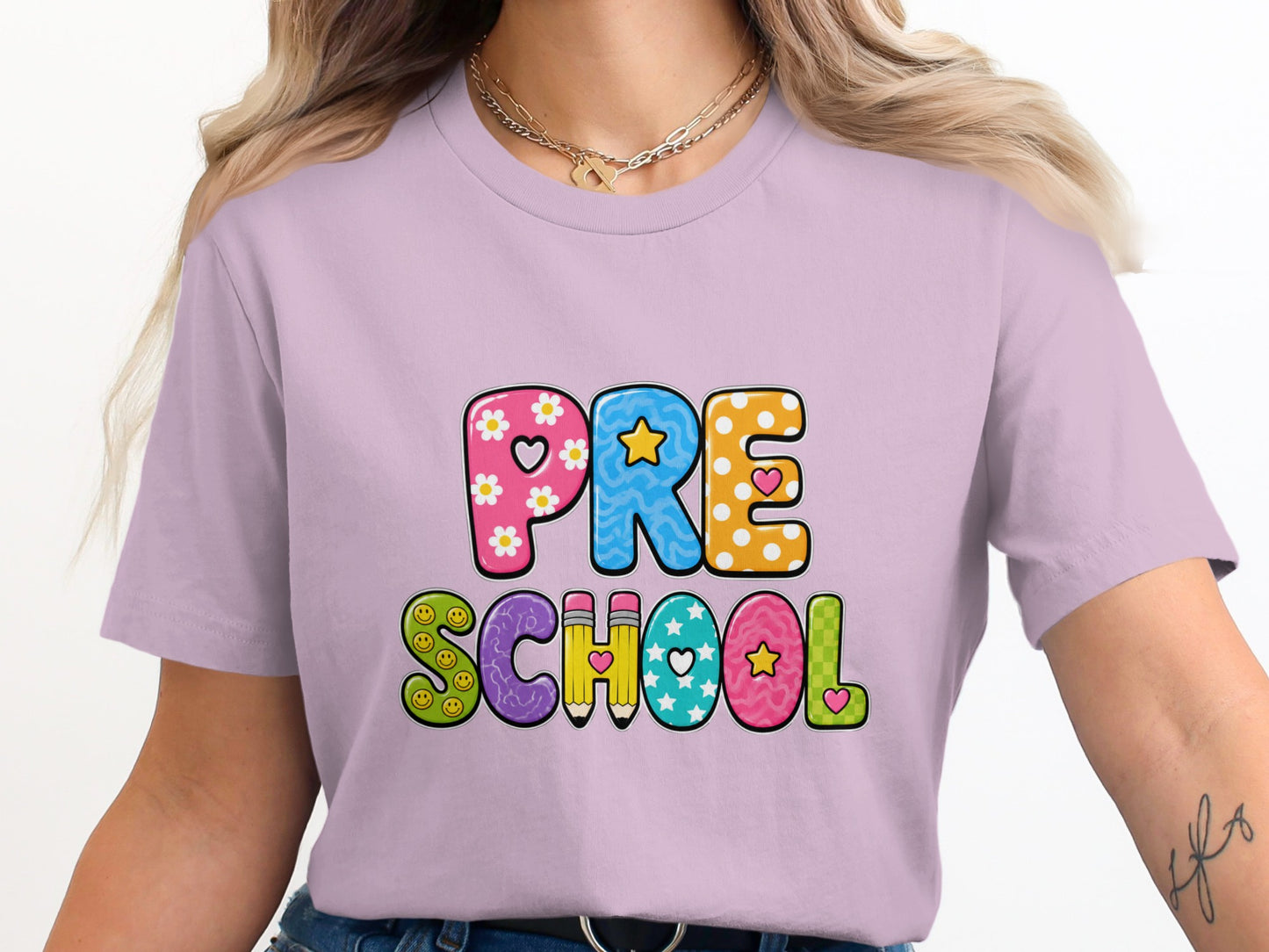 Lilac t-shirt with "PRE SCHOOL" text and playful, colorful letters.