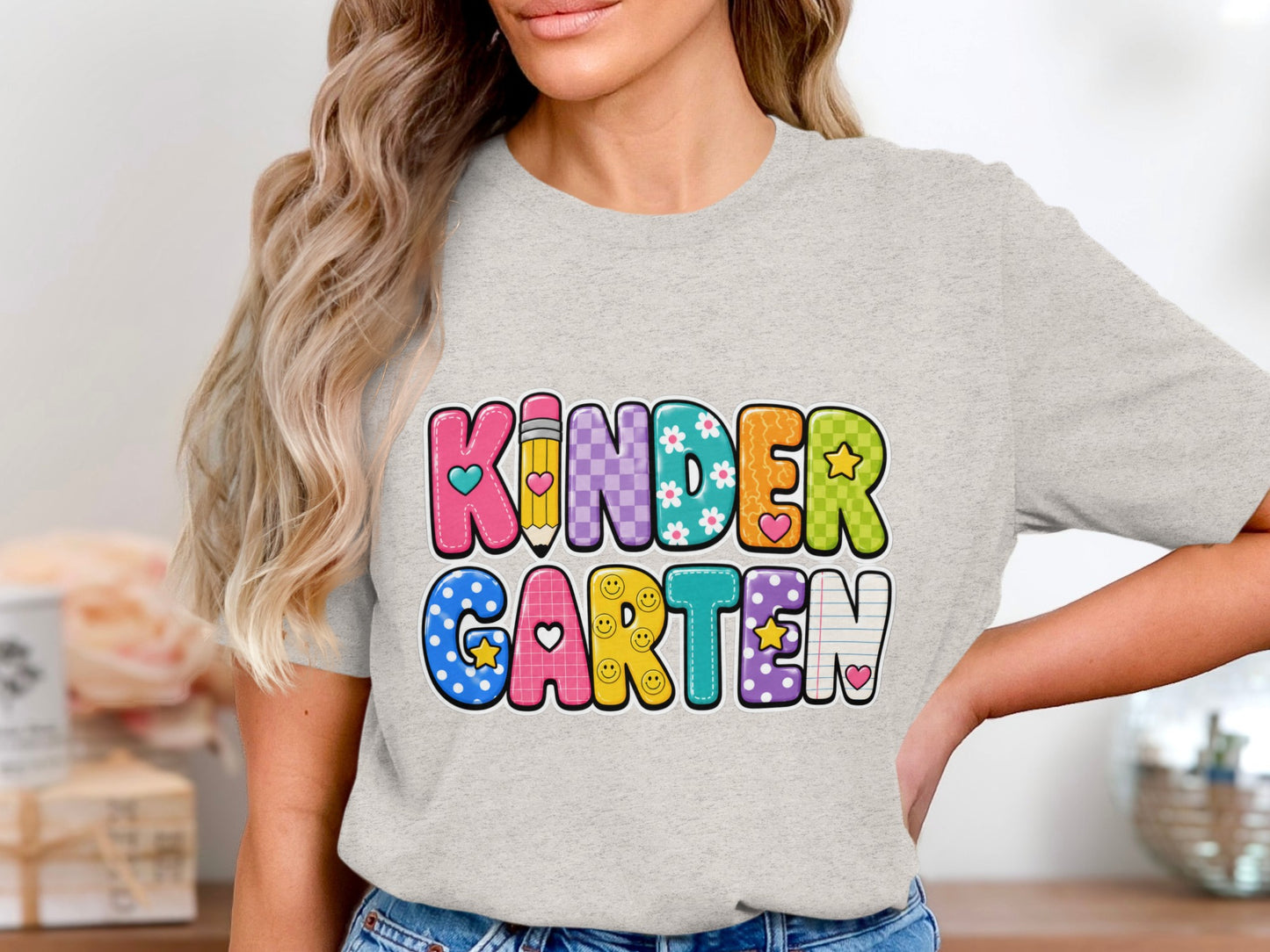 Light grey t-shirt with colorful "KINDERGARTEN" text in playful fonts.