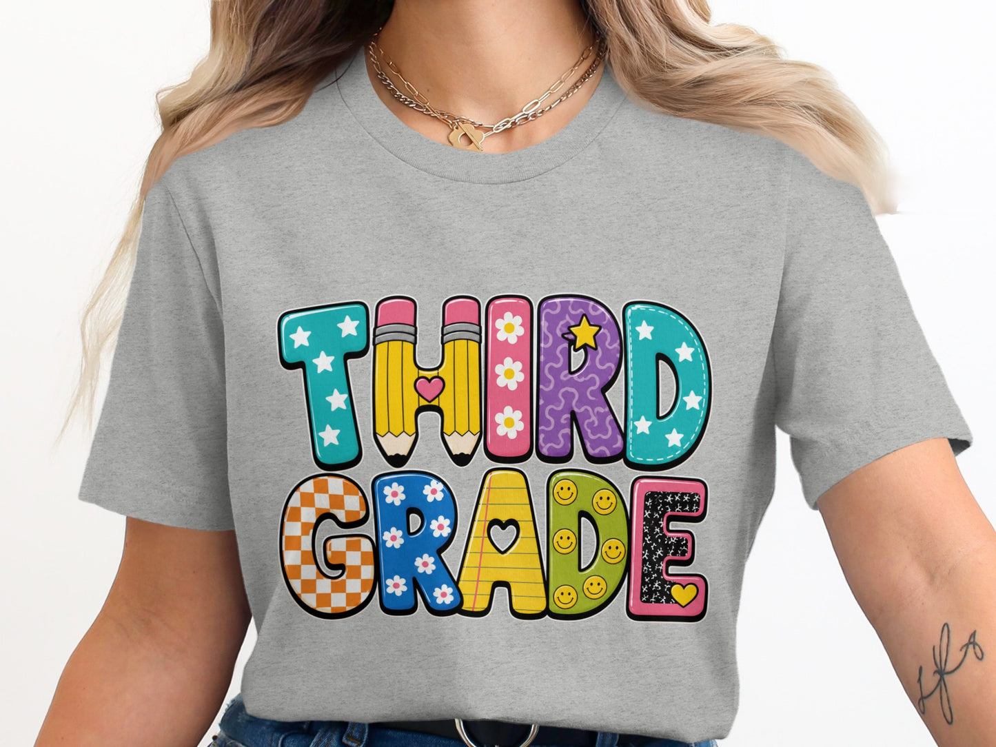 "THIRD GRADE" text on a grey t-shirt with playful, colorful letters.