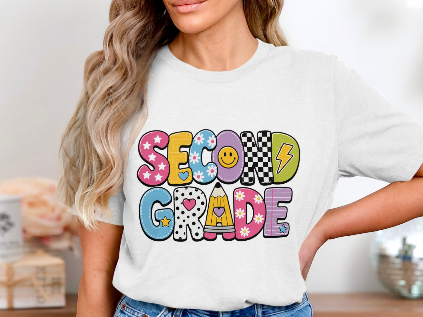White t-shirt with "SECOND GRADE" text in colorful, patterned letters.