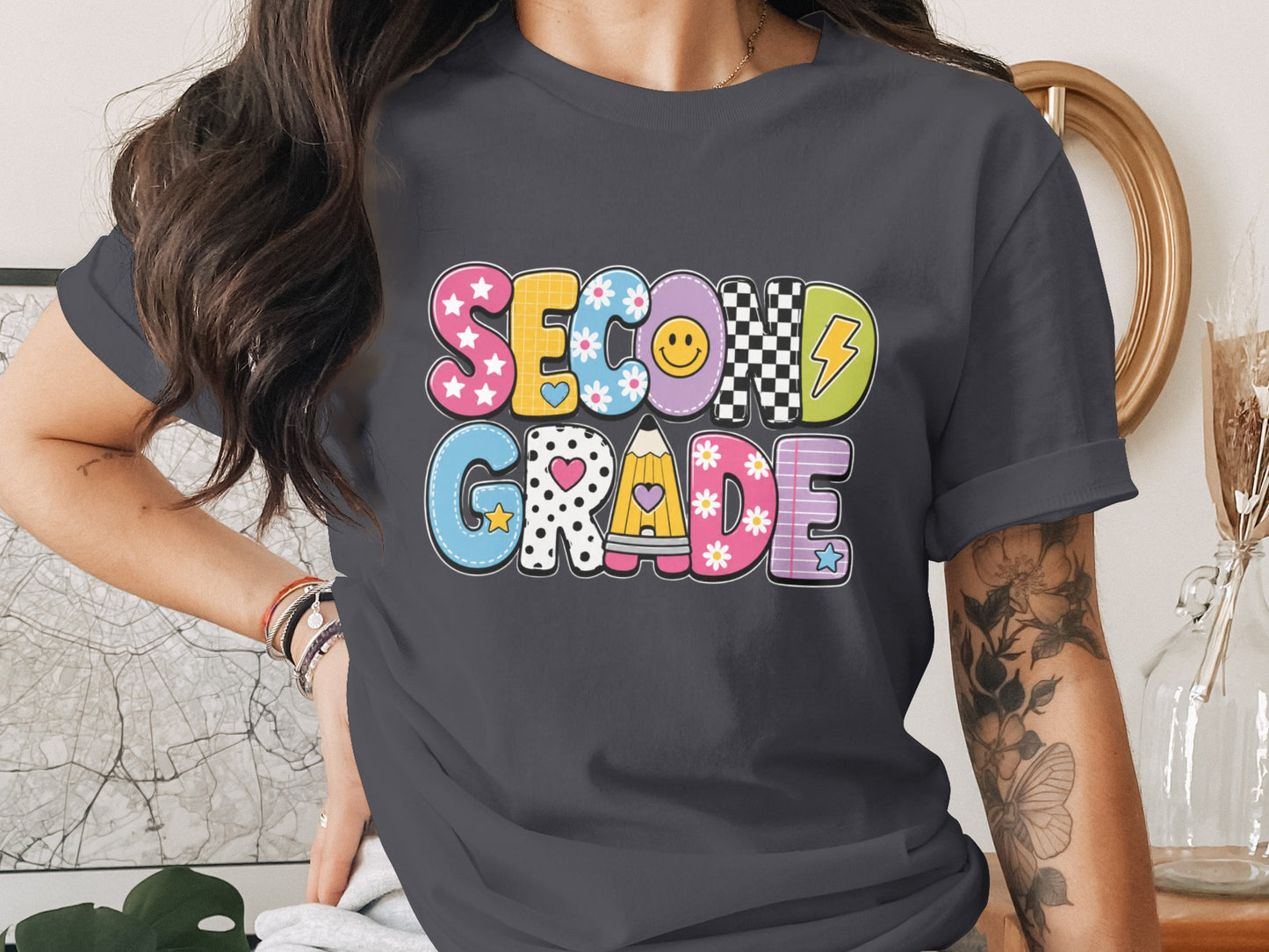"Second Grade" text with colorful bubble letters and playful school-themed graphics.