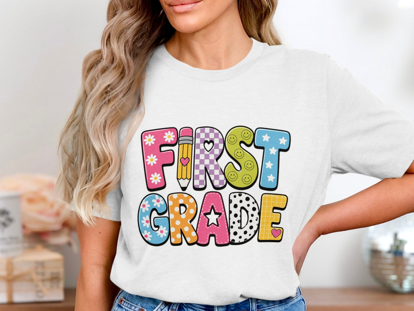White t-shirt with "FIRST GRADE" in colorful cartoon letters.