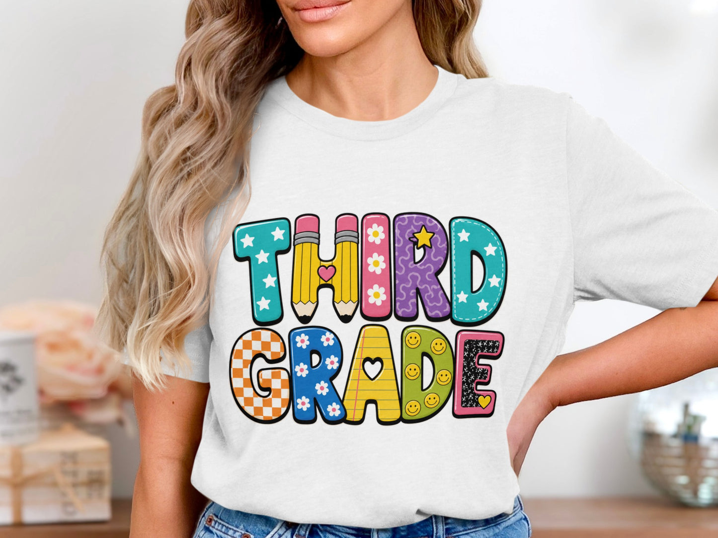 "Third Grade" text on a white t-shirt with colorful letter designs.