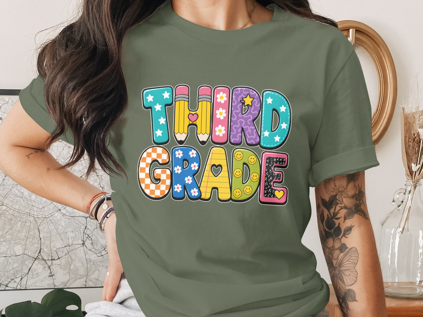 "Third Grade" text with colorful, patterned letters featuring pencils, flowers, stars, and smiley faces.