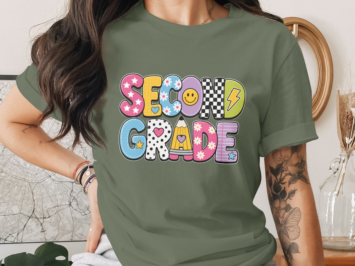 Green t-shirt with "SECOND GRADE" in colorful, patterned bubble letters.