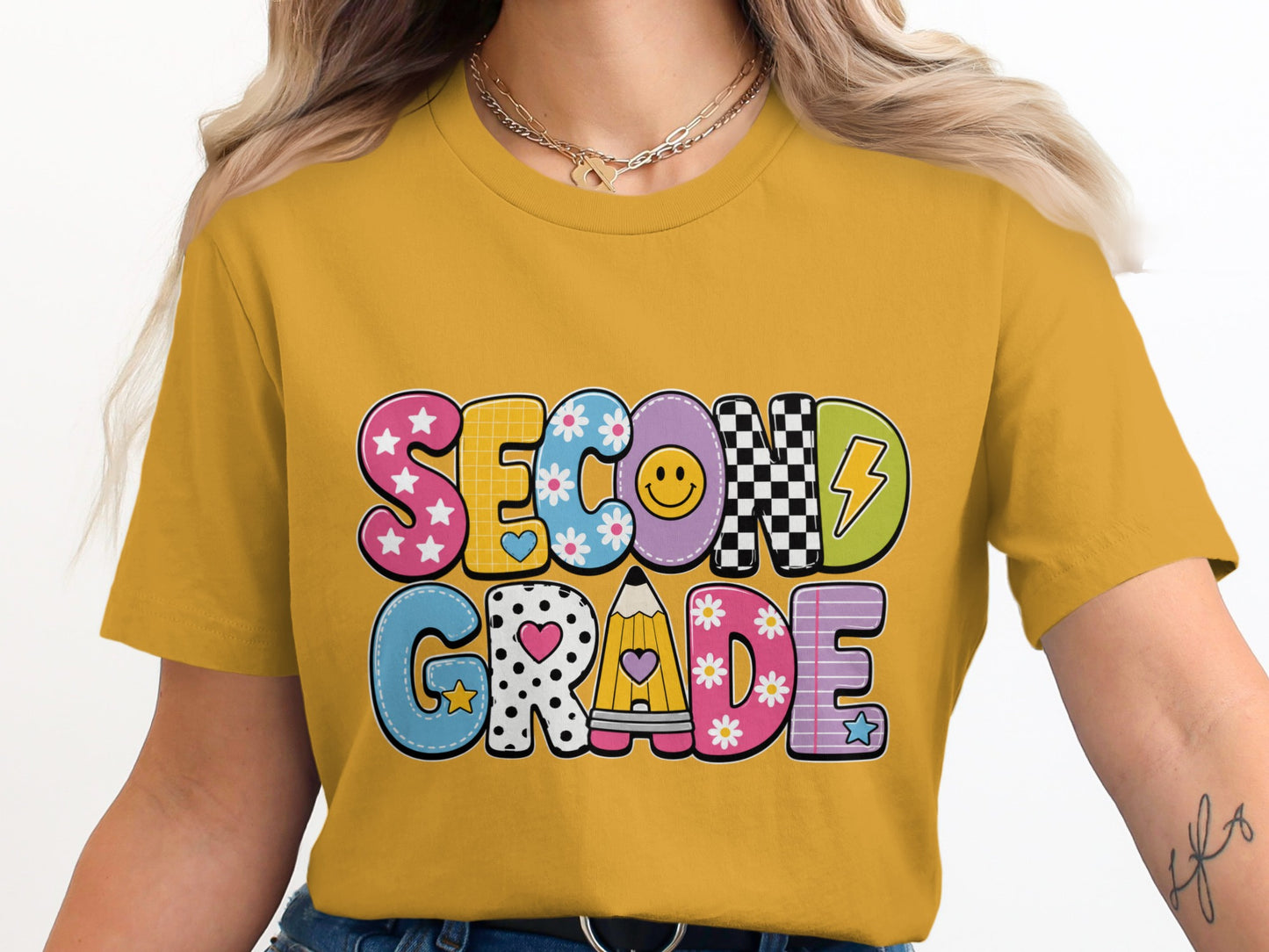 Yellow t-shirt with "SECOND GRADE" text in colorful, patterned block letters.