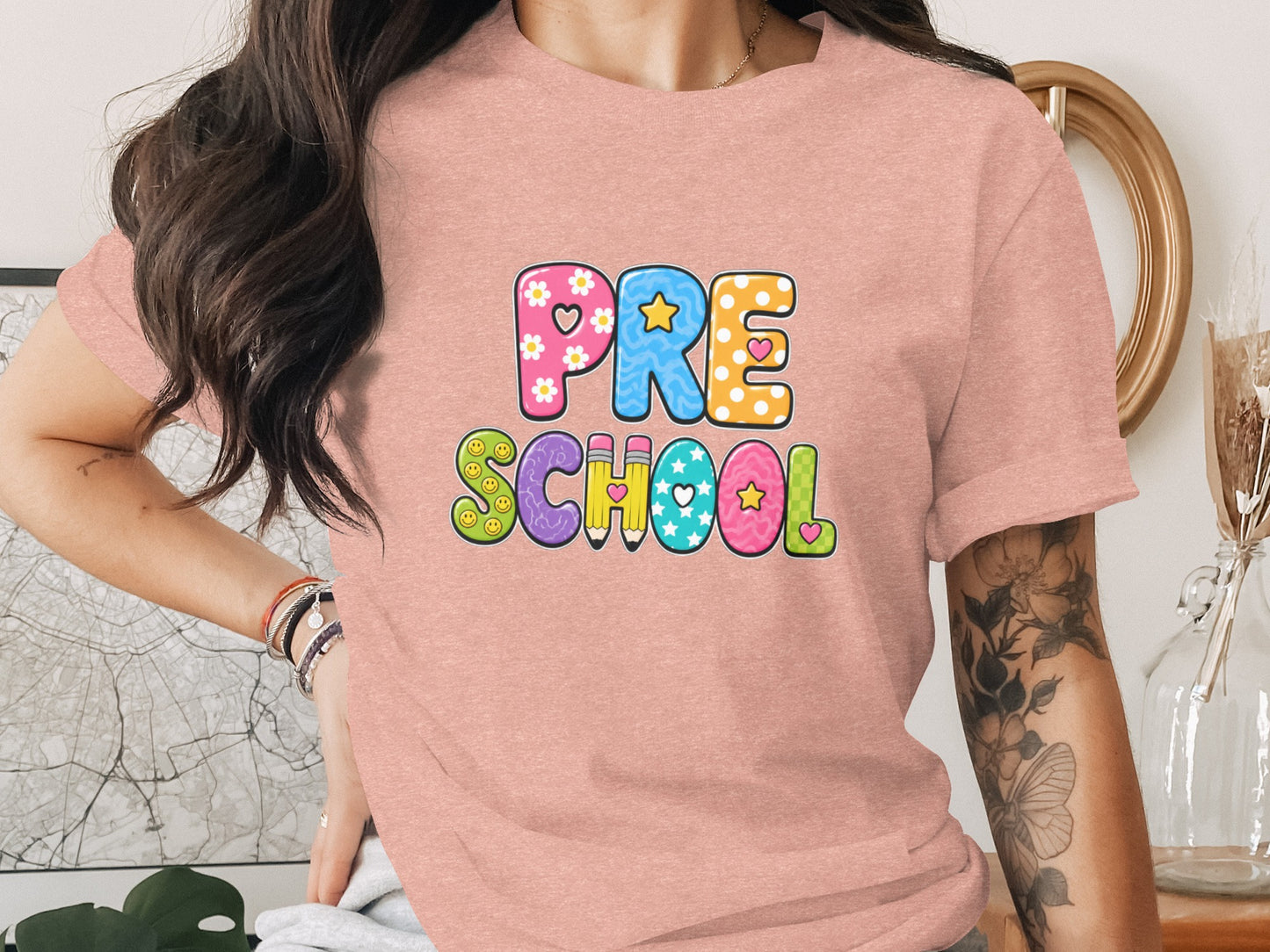 Pink t-shirt with colorful "PRE SCHOOL" text and whimsical cartoon elements.