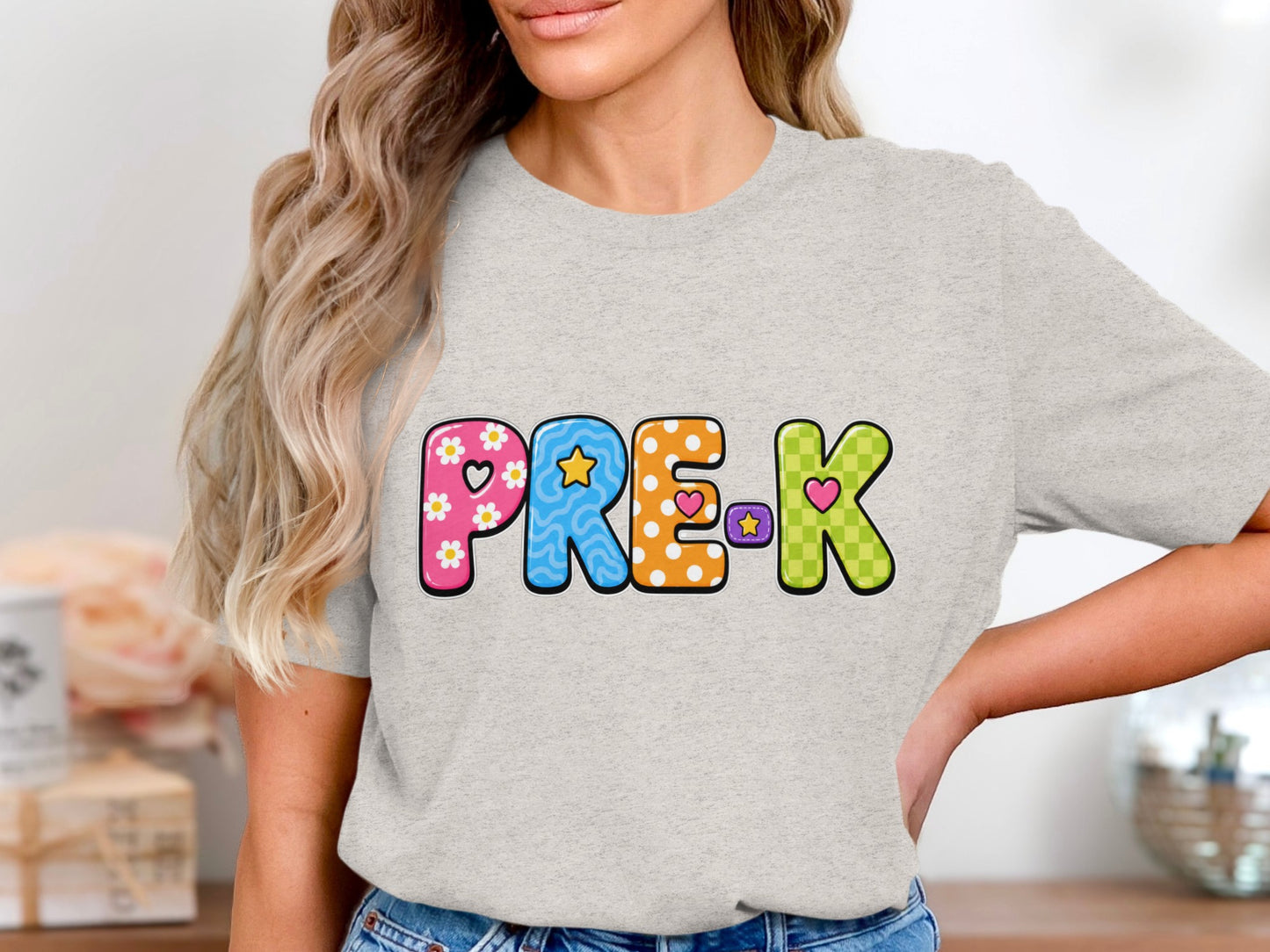 Gray t-shirt with colorful "PRE-K" text featuring patterns and hearts.