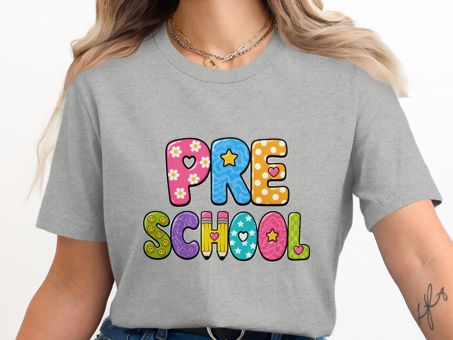 Grey t-shirt with colorful "PRE SCHOOL" text featuring flowers, stars, and smiley faces.